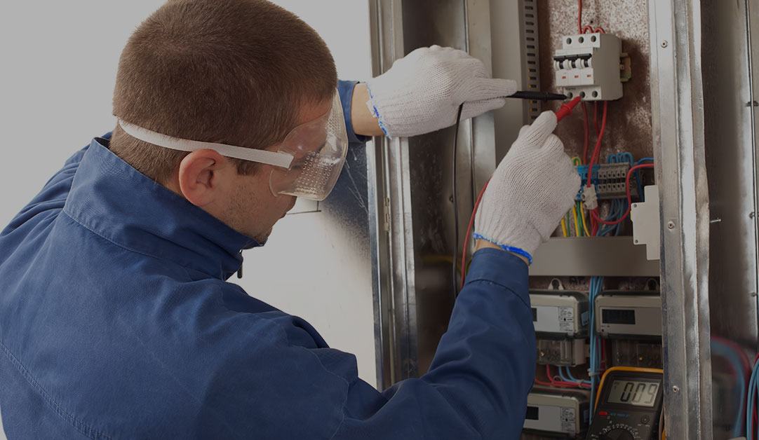 electrician-checking-the-energy-meter Electrician Checking the Energy Meter