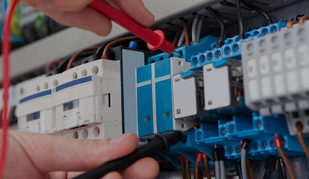 electrician-examining-fusebox Electrician Examining Fusebox